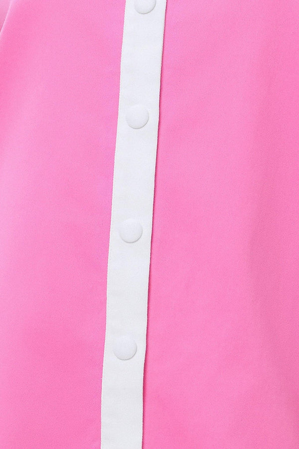 Close-up of a pink garment with a white trim