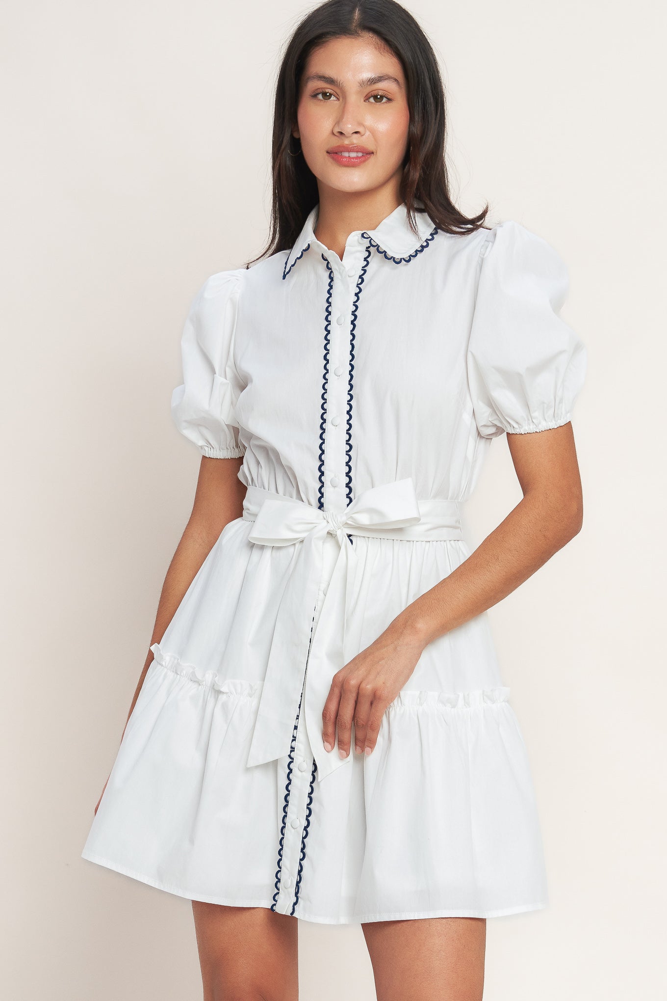 White short-sleeve button-front dress with navy trim and waist tie