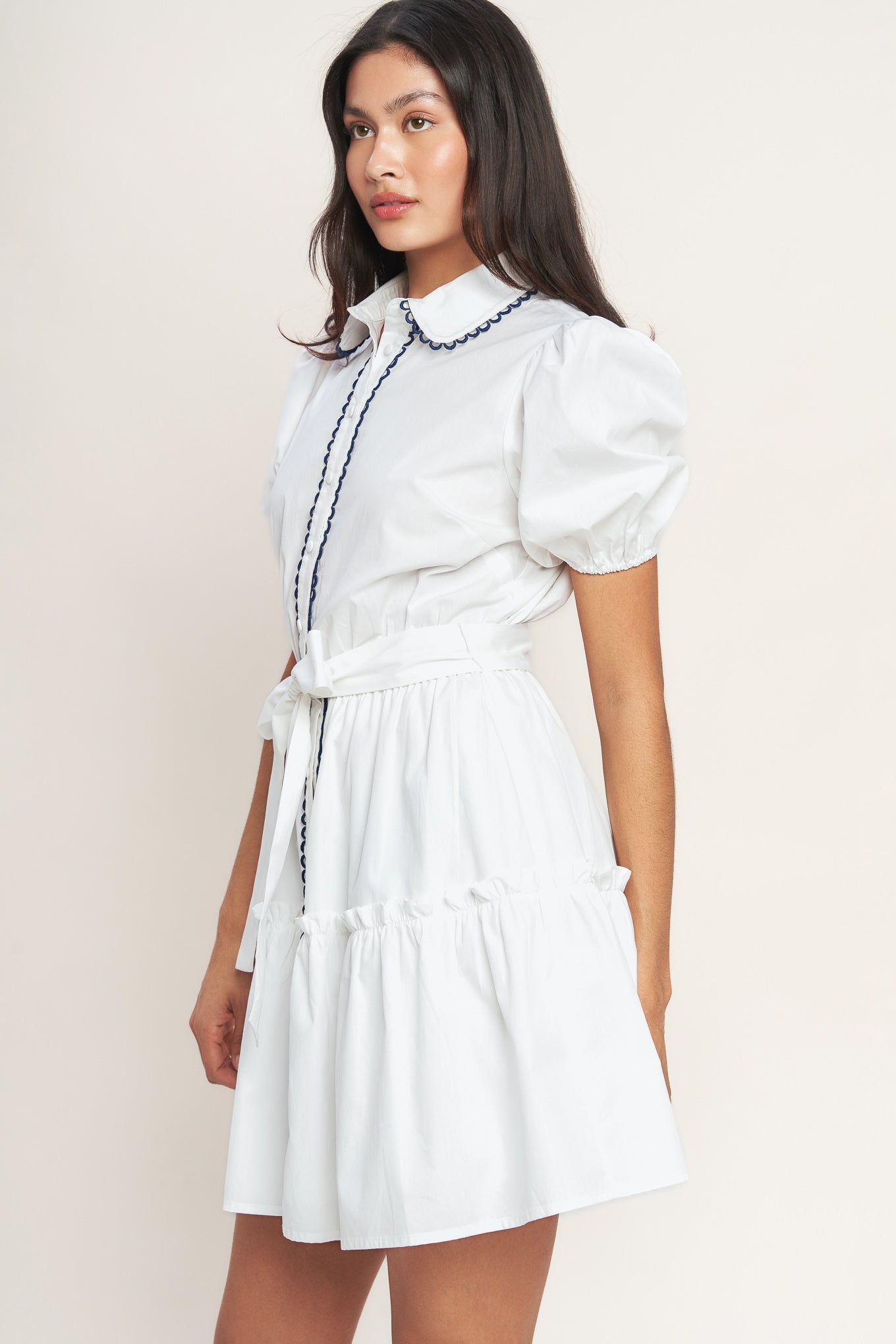 White short-sleeve button-front dress with navy trim and waist tie