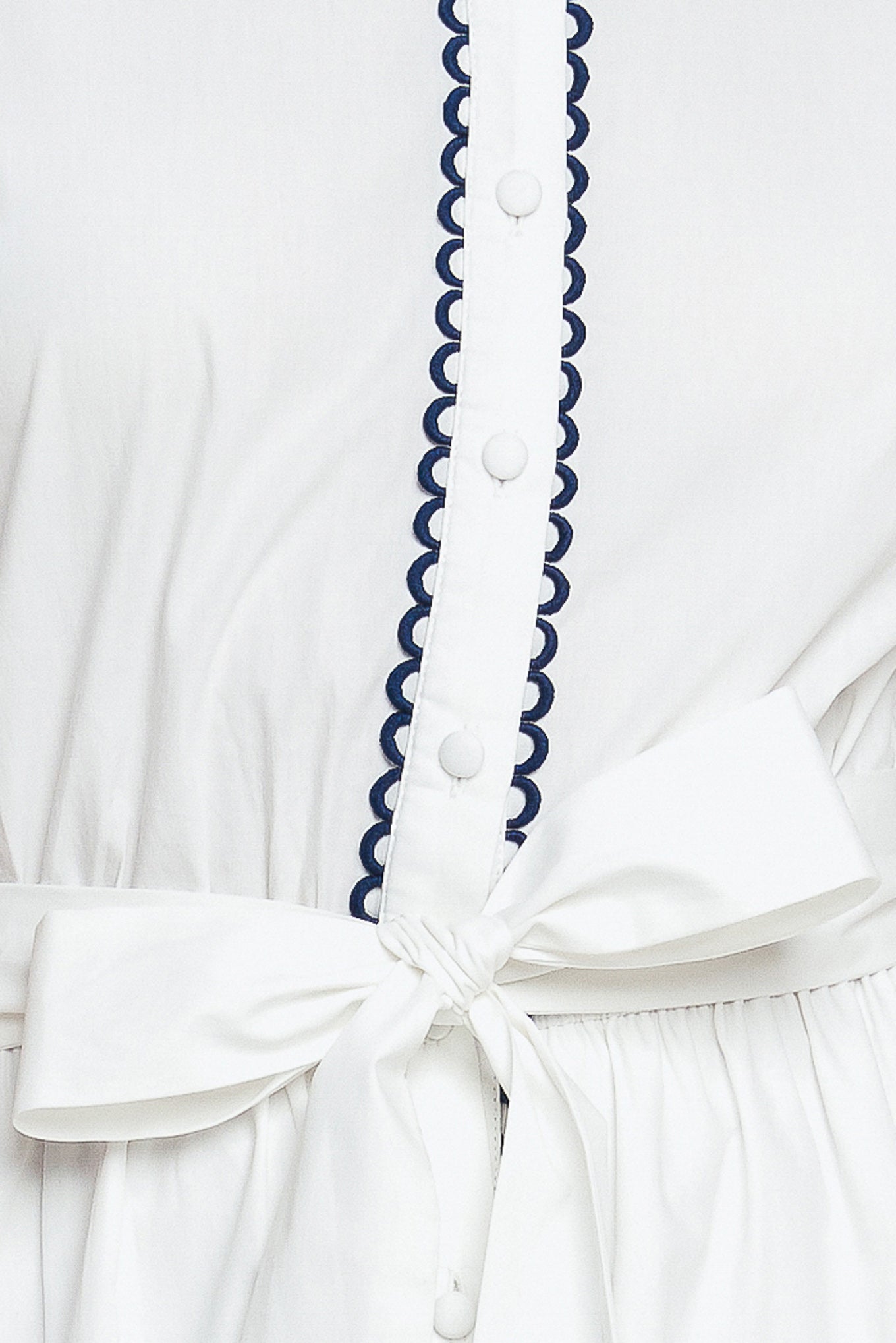 White short-sleeve button-front dress with navy trim and waist tie