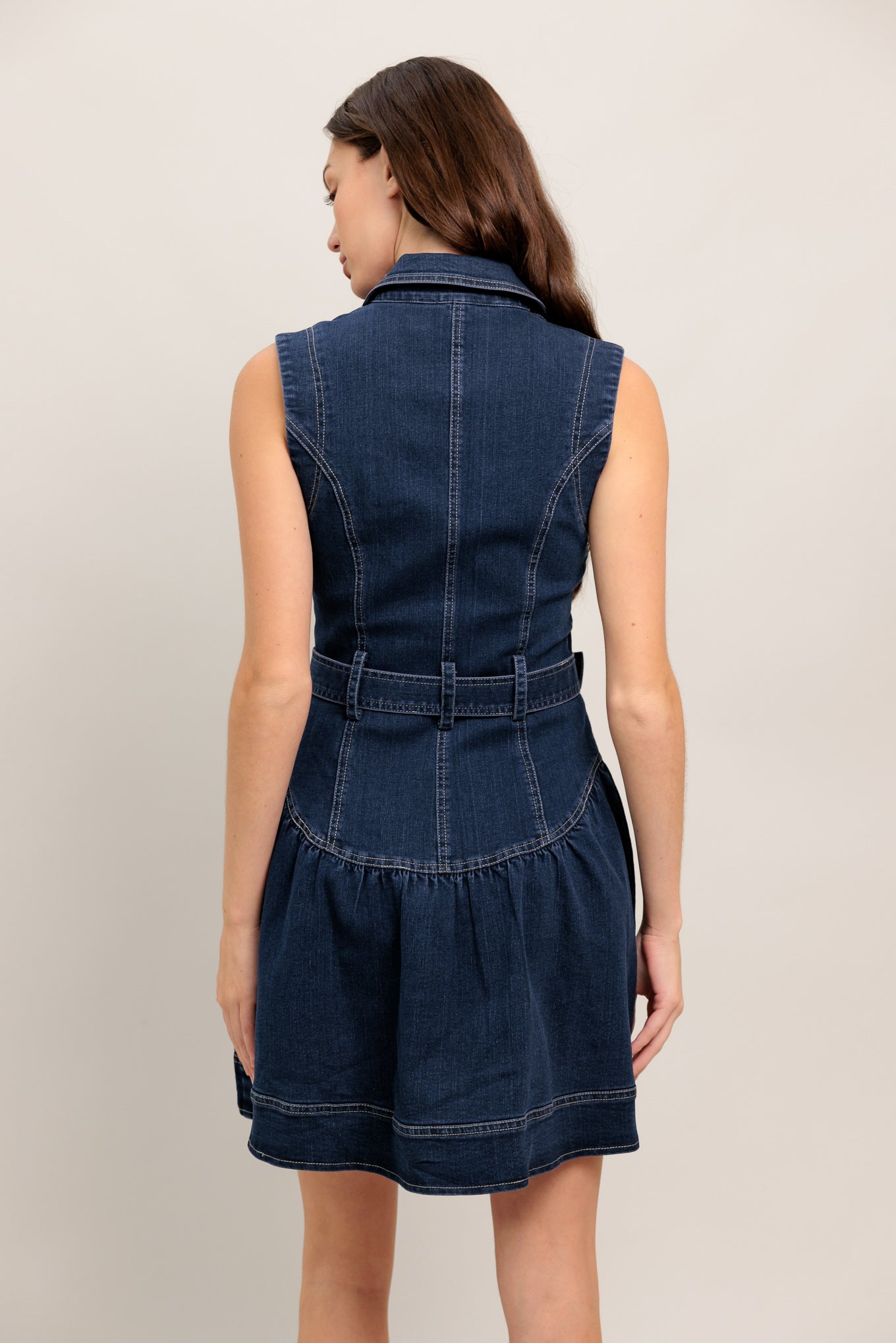 A denim mini dress featuring lapel, sleeveless, drop waistline, front button down and self belt

Details:

Self: 70% Cotton 28% Polyester 2% Spandex

Size & Fit

- Model is 5`8" And Wearing Size Small
- Measurements Taken From Size Small
- Approx. Length: 35"