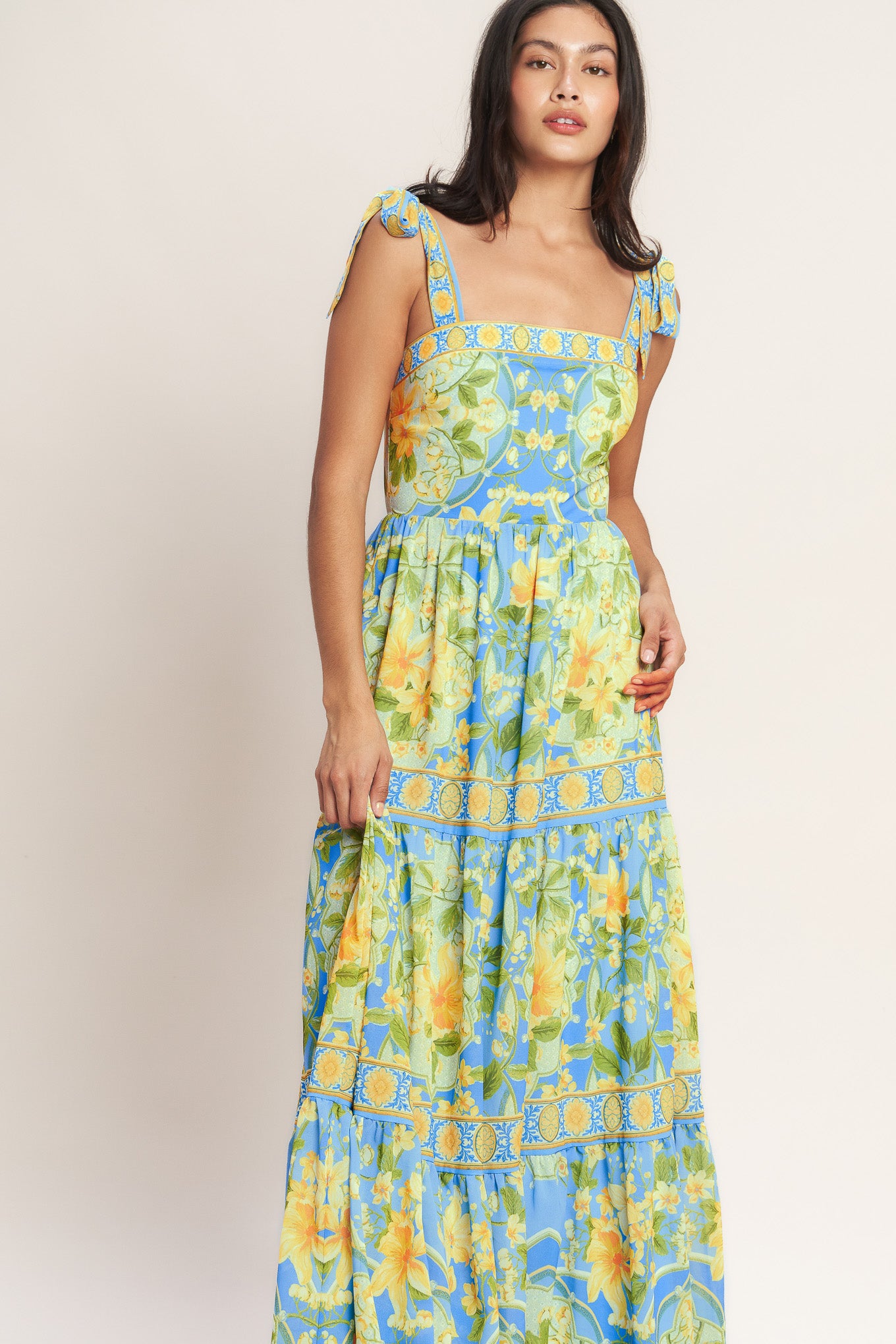 
A printed woven maxi dress featuring straight neckline, shoulder ties, tiered skirt and back zipper closure

Details:

Self : 100% Polyester
Lining : 100% Polyester

Size &amp; Fit

- Model is 5`8" And Wearing Size Small
- Measurements Taken From Size Small
- Approx. Length: 61" Flying Tomato