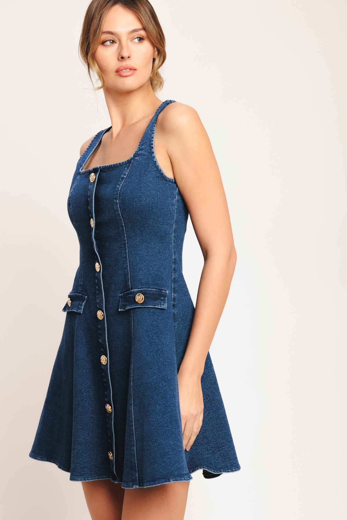 A washed denim mini dress featuring square neckline, sleeveless, button down detail, circle skirt and back zipper closure

Details:

Self: 70% Cotton 28% Polyester 2% Spandex

Size & Fit

-Model is 5`8" And Wearing Size Small
-Measurements Taken From Size Small
-Approx. Length: 34"