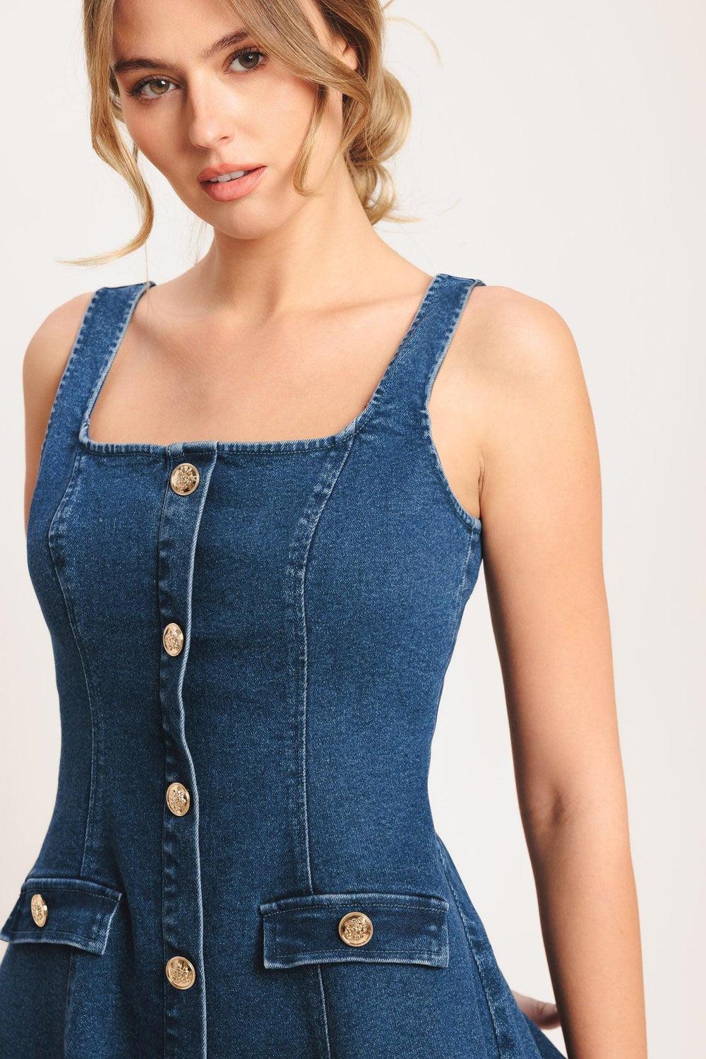 A washed denim mini dress featuring square neckline, sleeveless, button down detail, circle skirt and back zipper closure

Details:

Self: 70% Cotton 28% Polyester 2% Spandex

Size & Fit

-Model is 5`8" And Wearing Size Small
-Measurements Taken From Size Small
-Approx. Length: 34"