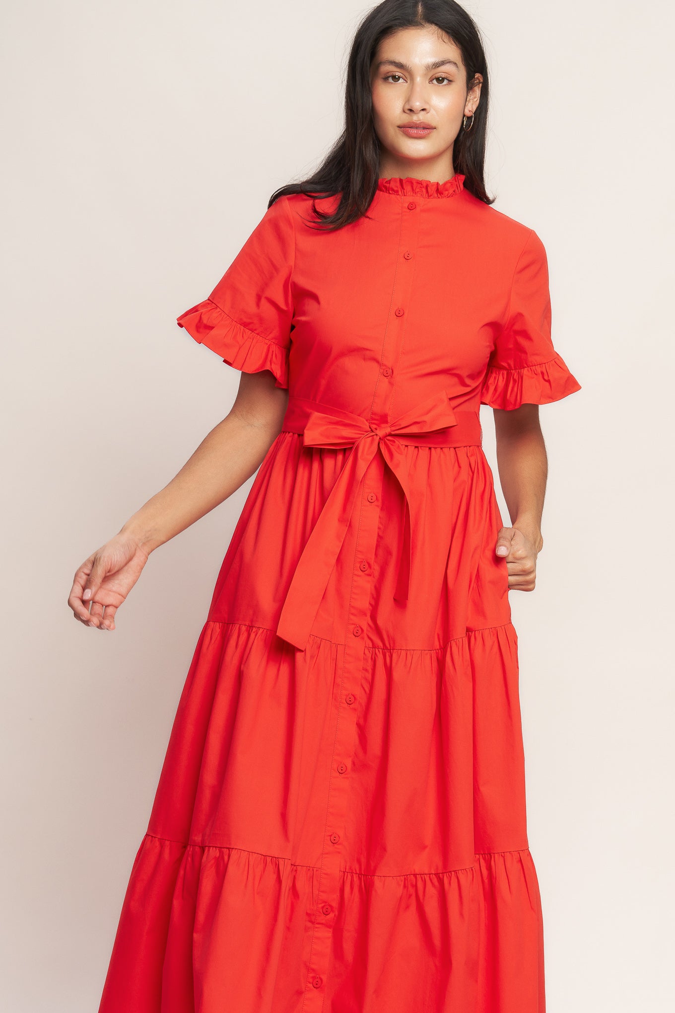 A solid woven midi dress featuring high ruffle neckline, short sleeve with ruffled edge, front button down, self sash tie and tiered skirt

Details:

Self : 100% Cotton
Lining : 100% Polyester

Size &amp; Fit

- Model is 5`8" And Wearing Size Small
- Measurements Taken From Size Small
- Approx. Length: 52" FYING TOMATO