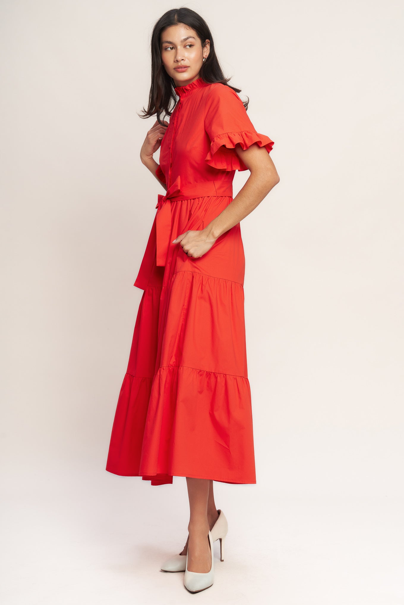 A solid woven midi dress featuring high ruffle neckline, short sleeve with ruffled edge, front button down, self sash tie and tiered skirt

Details:

Self : 100% Cotton
Lining : 100% Polyester

Size &amp; Fit

- Model is 5`8" And Wearing Size Small
- Measurements Taken From Size Small
- Approx. Length: 52" FYING TOMATO