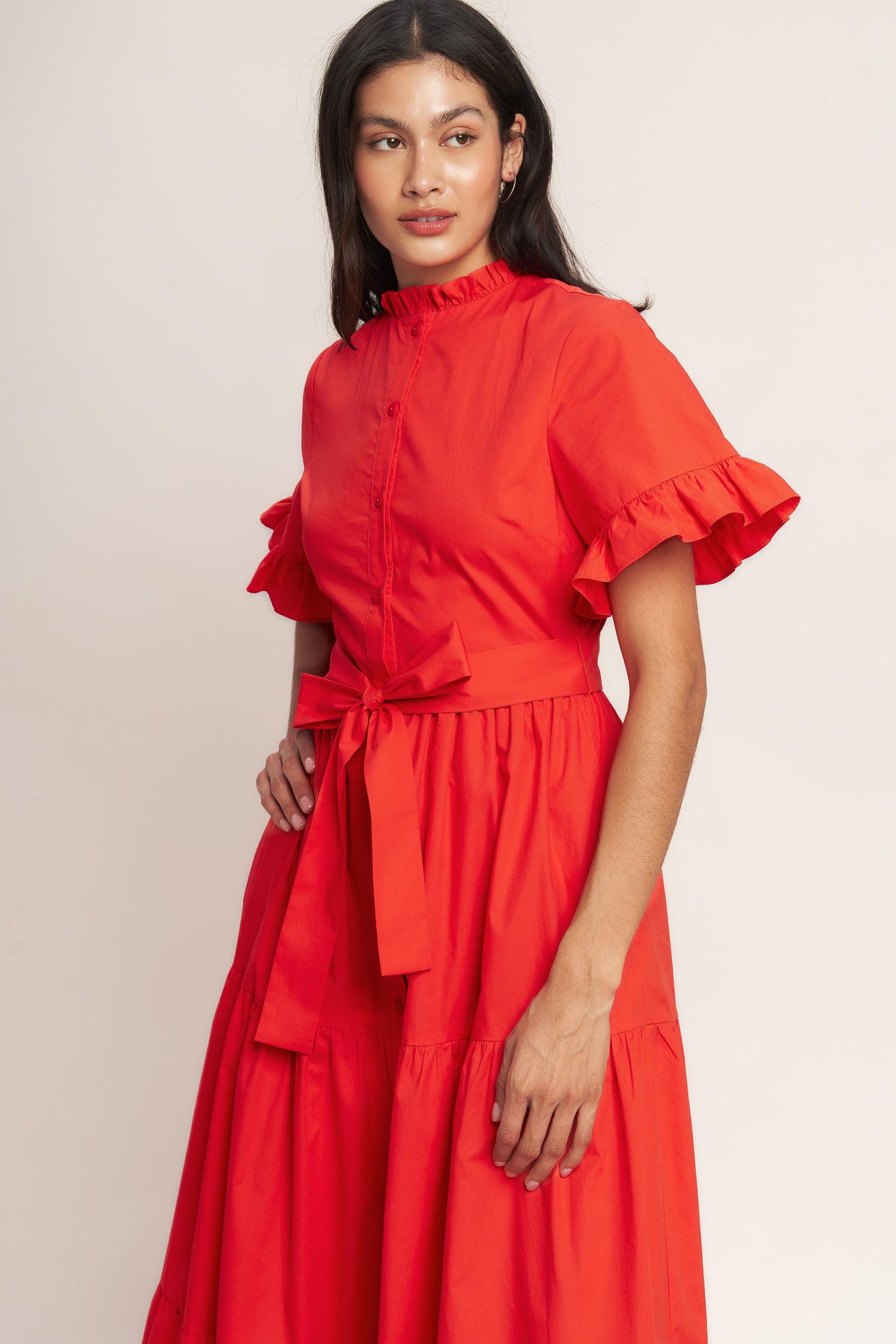 A solid woven midi dress featuring high ruffle neckline, short sleeve with ruffled edge, front button down, self sash tie and tiered skirt

Details:

Self : 100% Cotton
Lining : 100% Polyester

Size &amp; Fit

- Model is 5`8" And Wearing Size Small
- Measurements Taken From Size Small
- Approx. Length: 52" FYING TOMATO
