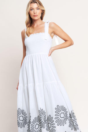 A solid woven midi dress featuring contrasting ruffle edge, shoulder tie and embroidered skirt

Details:

Self: 100% Cotton

Lining: 100% Polyester

Size & Fit

-Model is 5`8" And Wearing Size Small
-Measurements Taken From Size Small
-Approx. Length: 50"