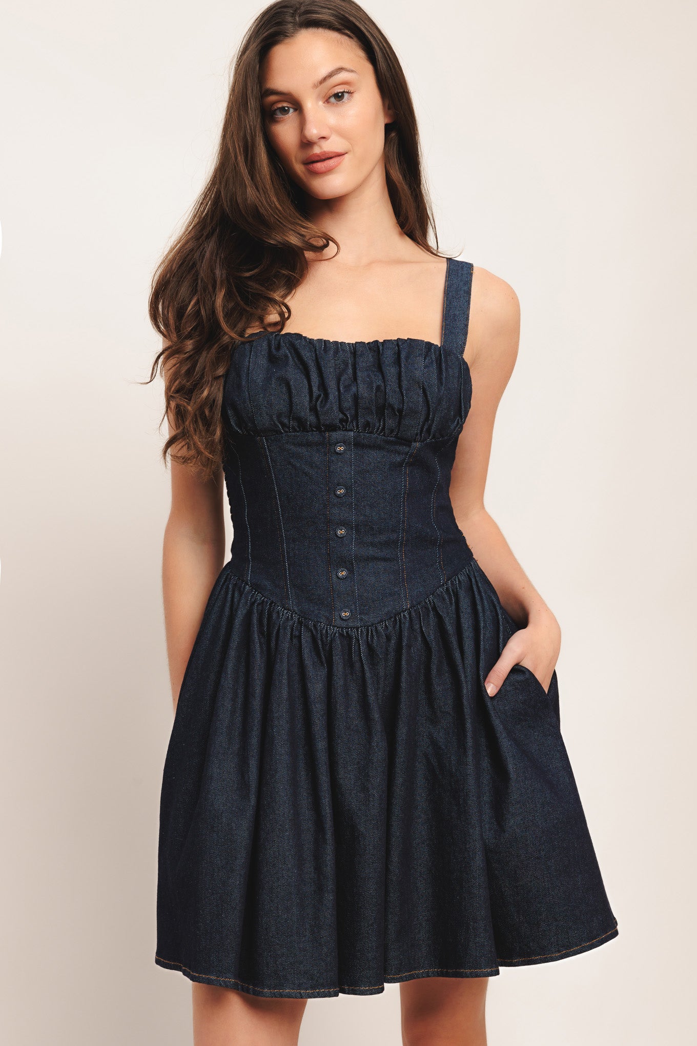 A denim mini dress featuring straight neckline, ruched bust, straps, corset waist with button detail, full skirt and smocked back bodice

Details:

Self: 98% Cotton 2% Spandex

Lining: 100% Polyester

Size & Fit

-Model is 5`8" And Wearing Size Small
-Measurements Taken From Size Small
-Approx. Length: 35"