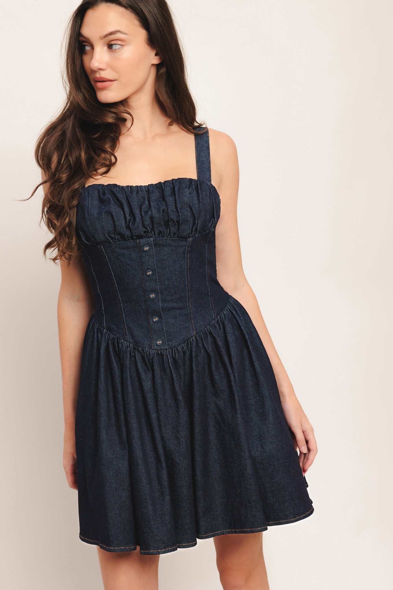 A denim mini dress featuring straight neckline, ruched bust, straps, corset waist with button detail, full skirt and smocked back bodice

Details:

Self: 98% Cotton 2% Spandex

Lining: 100% Polyester

Size & Fit

-Model is 5`8" And Wearing Size Small
-Measurements Taken From Size Small
-Approx. Length: 35"
