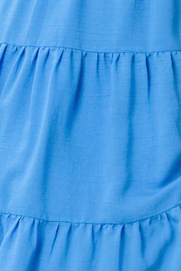 Close-up of a blue dress with tiered layers