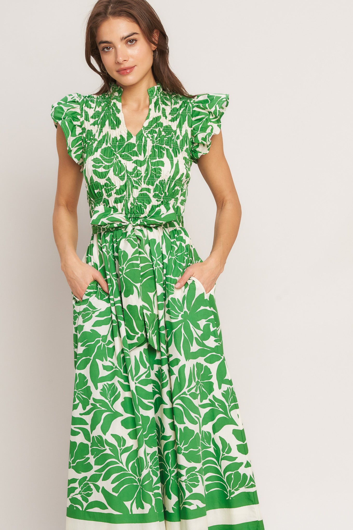 A printed woven midi dress featuring ruffled neck with V front, ruffle sleeve, smocked bodice and full skirt