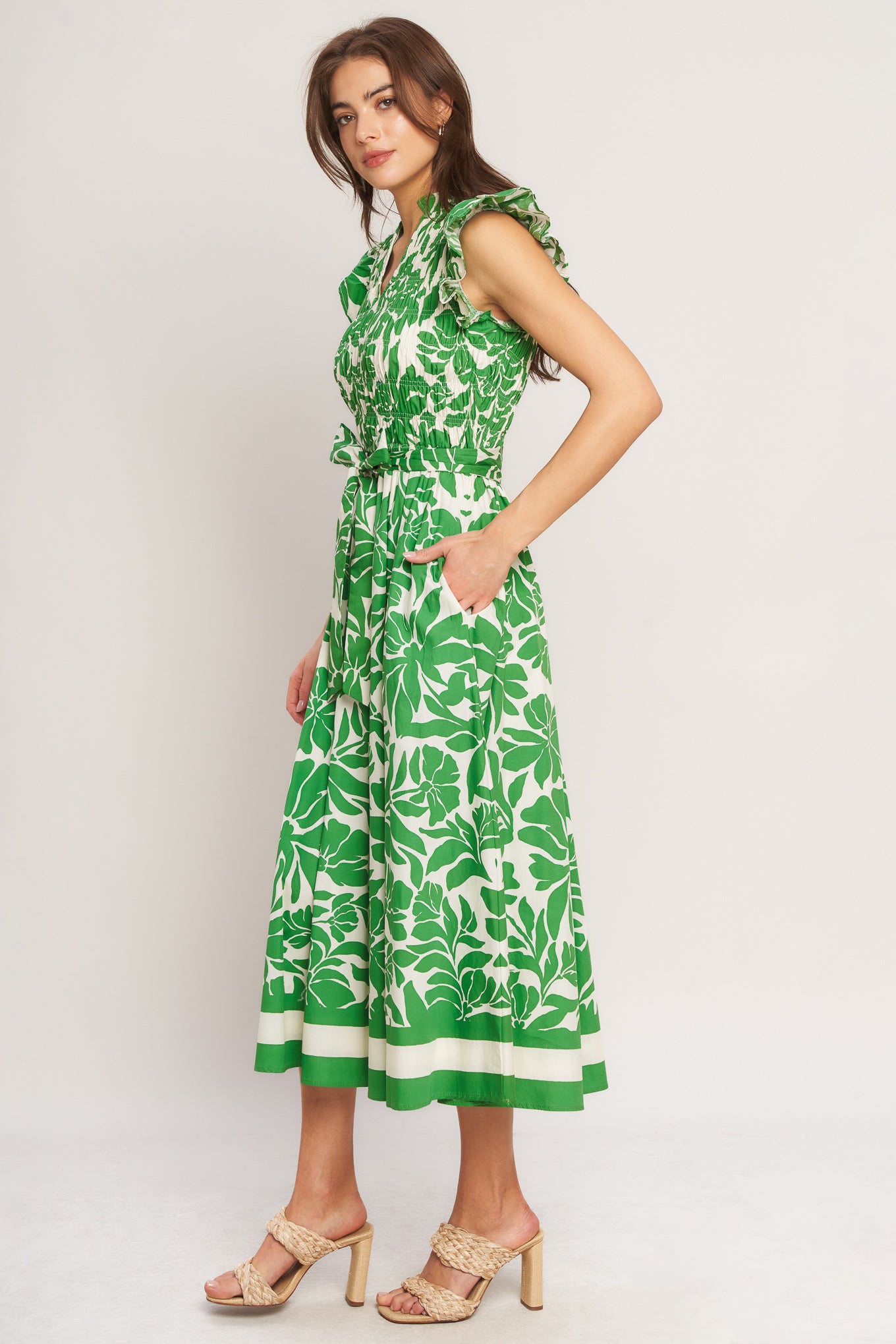 A printed woven midi dress featuring ruffled neck with V front, ruffle sleeve, smocked bodice and full skirt