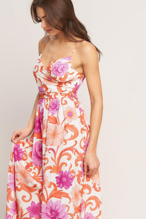 A printed woven midi dress featuring surplice cami top with shirred side, straps, full skirt and smocked back bodice