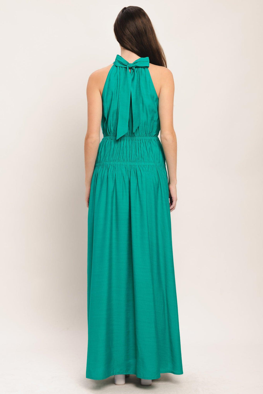 A solid woven maxi dress featuring halter neckline with back tie and elastic waist

Details:

Self: 65% Rayon 35% Nylon

Lining: 100% Polyester

Size & Fit

-Model is 5`8" And Wearing Size Small
-Measurements Taken From Size Small
-Approx. Length: 60"