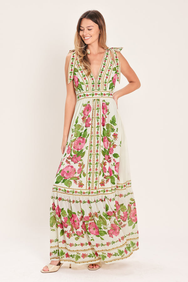 Woman wearing a floral maxi dress featuring V neckline, shoulder ties and smocked back waist band | Flying Tomato
