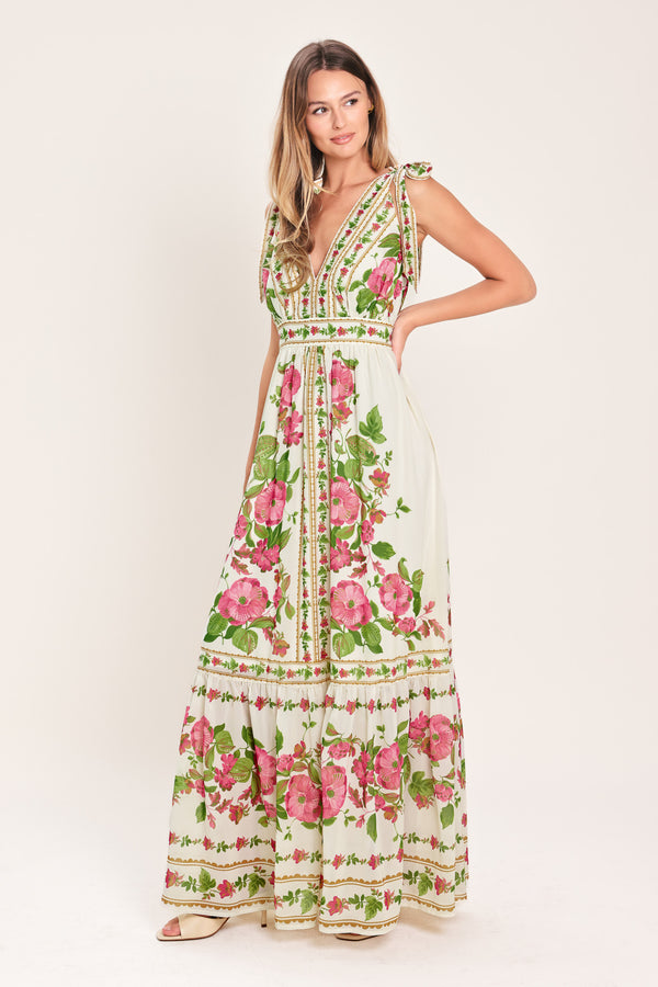 Woman wearing a floral maxi dress featuring V neckline, shoulder ties and smocked back waist band | Flying Tomato