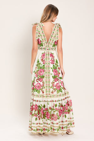 Woman wearing a floral maxi dress featuring V neckline, shoulder ties and smocked back waist band | Flying Tomato