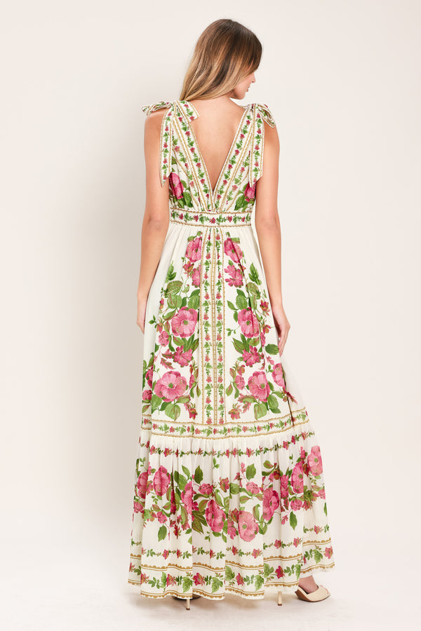 Woman wearing a floral maxi dress featuring V neckline, shoulder ties and smocked back waist band | Flying Tomato