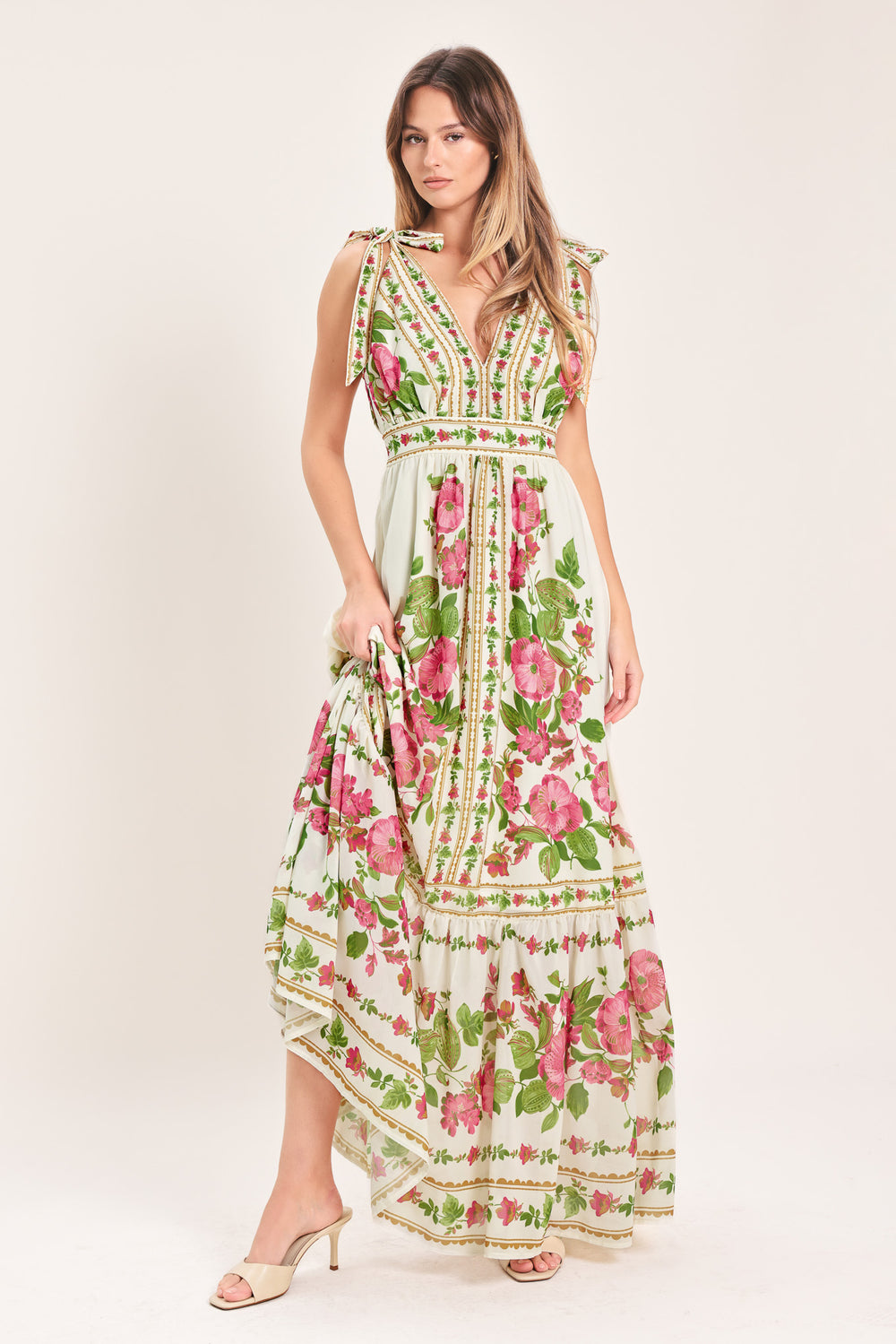 Woman wearing a floral maxi dress featuring V neckline, shoulder ties and smocked back waist band | Flying Tomato