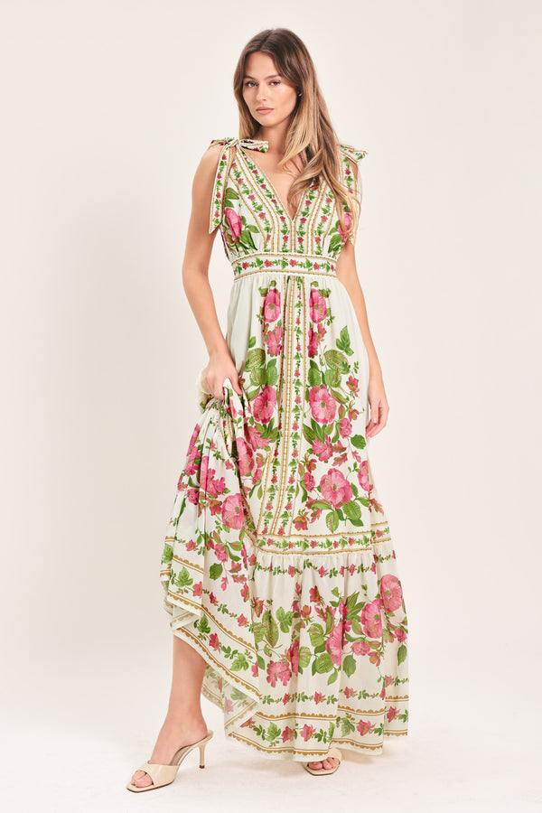 Woman wearing a floral maxi dress featuring V neckline, shoulder ties and smocked back waist band | Flying Tomato