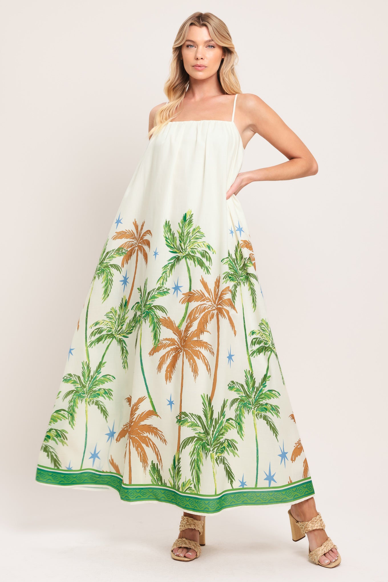 Woman wearing a white dress with green and rustic orange palm tree pattern | Flying Tomato