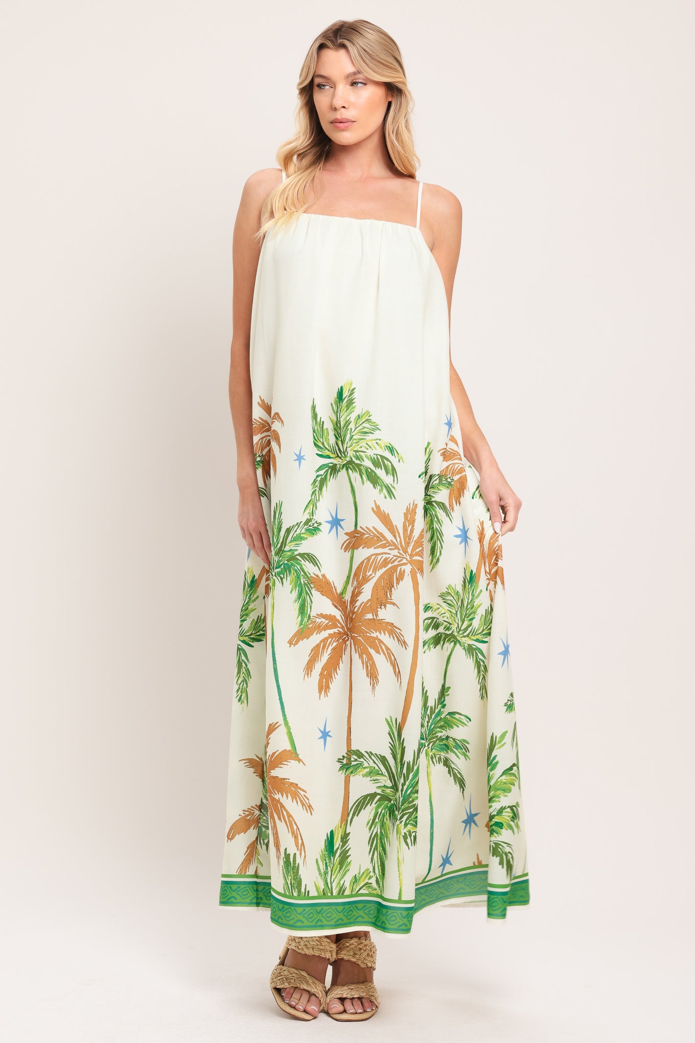 Woman wearing a white dress with green and rustic orange palm tree pattern | Flying Tomato