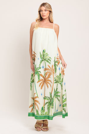 Woman wearing a white dress with green and rustic orange palm tree pattern | Flying Tomato