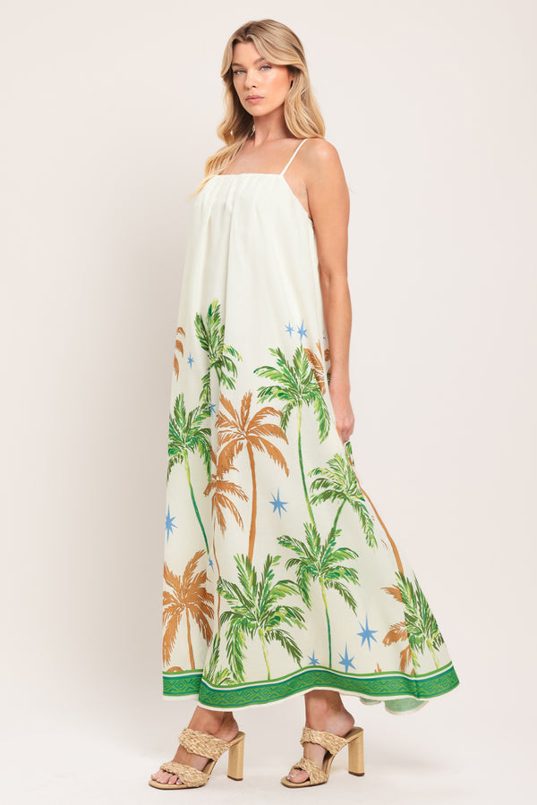 Woman wearing a white dress with green and rustic orange palm tree pattern | Flying Tomato