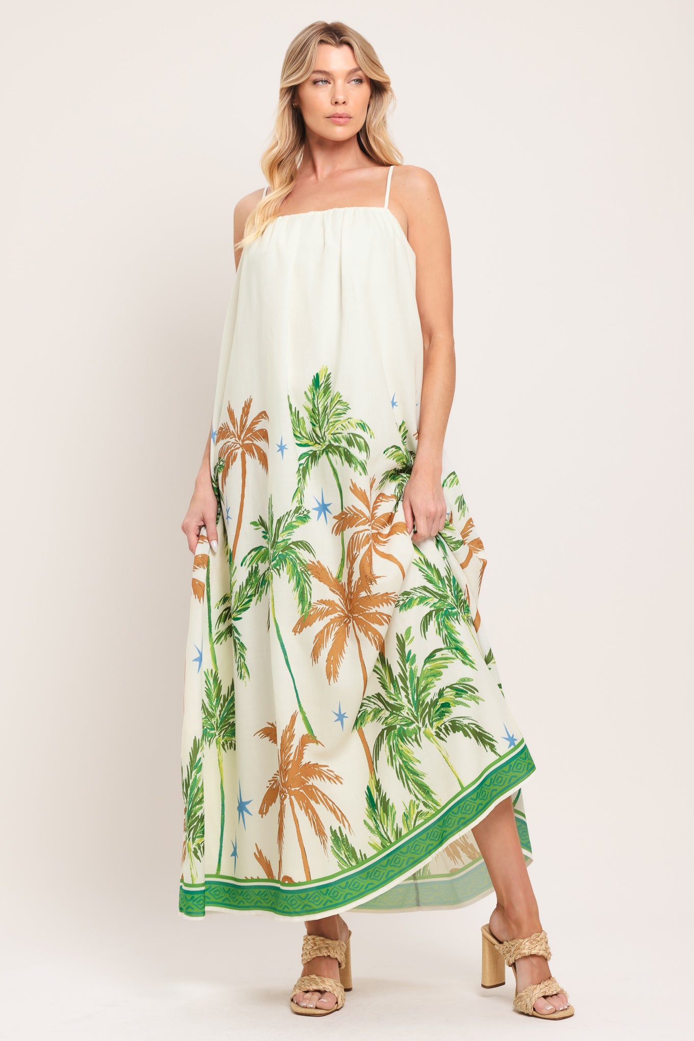 Woman wearing a white dress with green and rustic orange palm tree pattern | Flying Tomato
