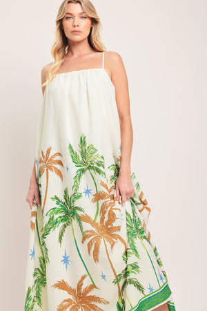 Woman wearing a white dress with green and rustic orange palm tree pattern | Flying Tomato