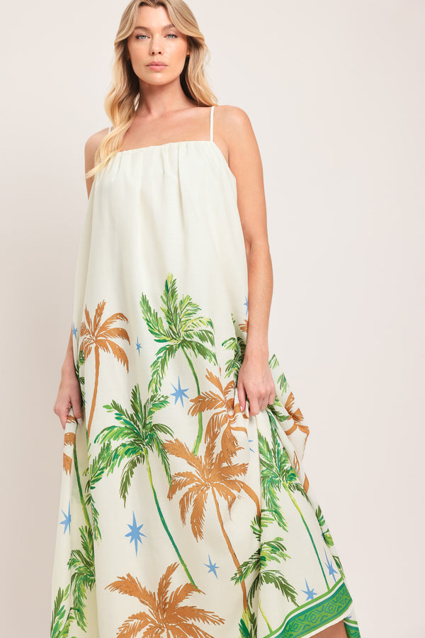 Woman wearing a white dress with green and rustic orange palm tree pattern | Flying Tomato