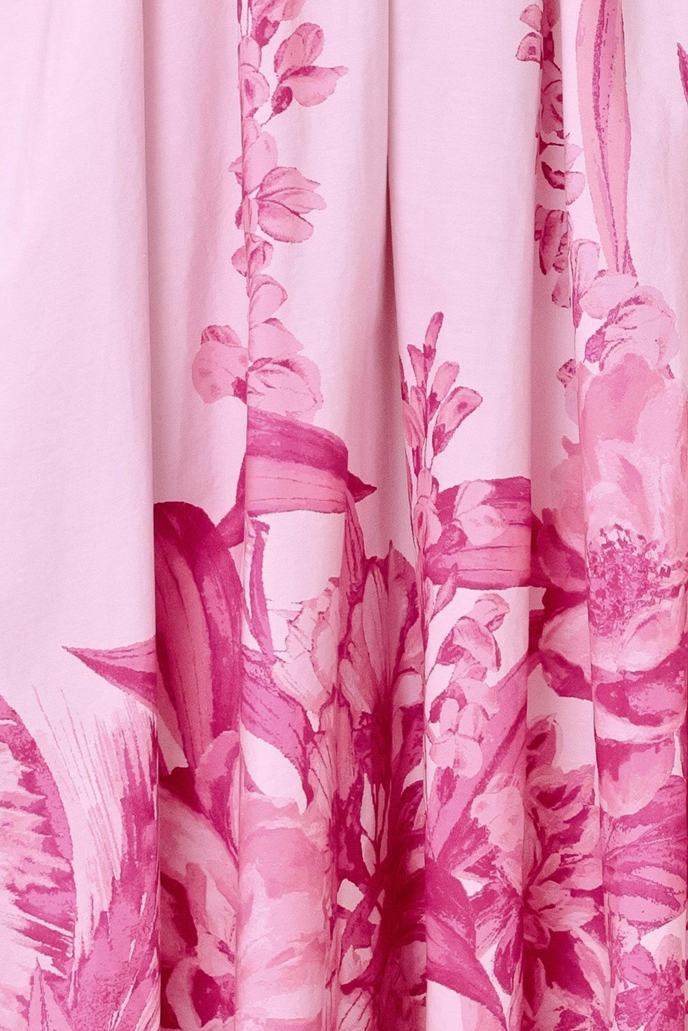 A pink floral printed woven midi dress featuring twist front with back neck tie, full skirt and smocked back bodice