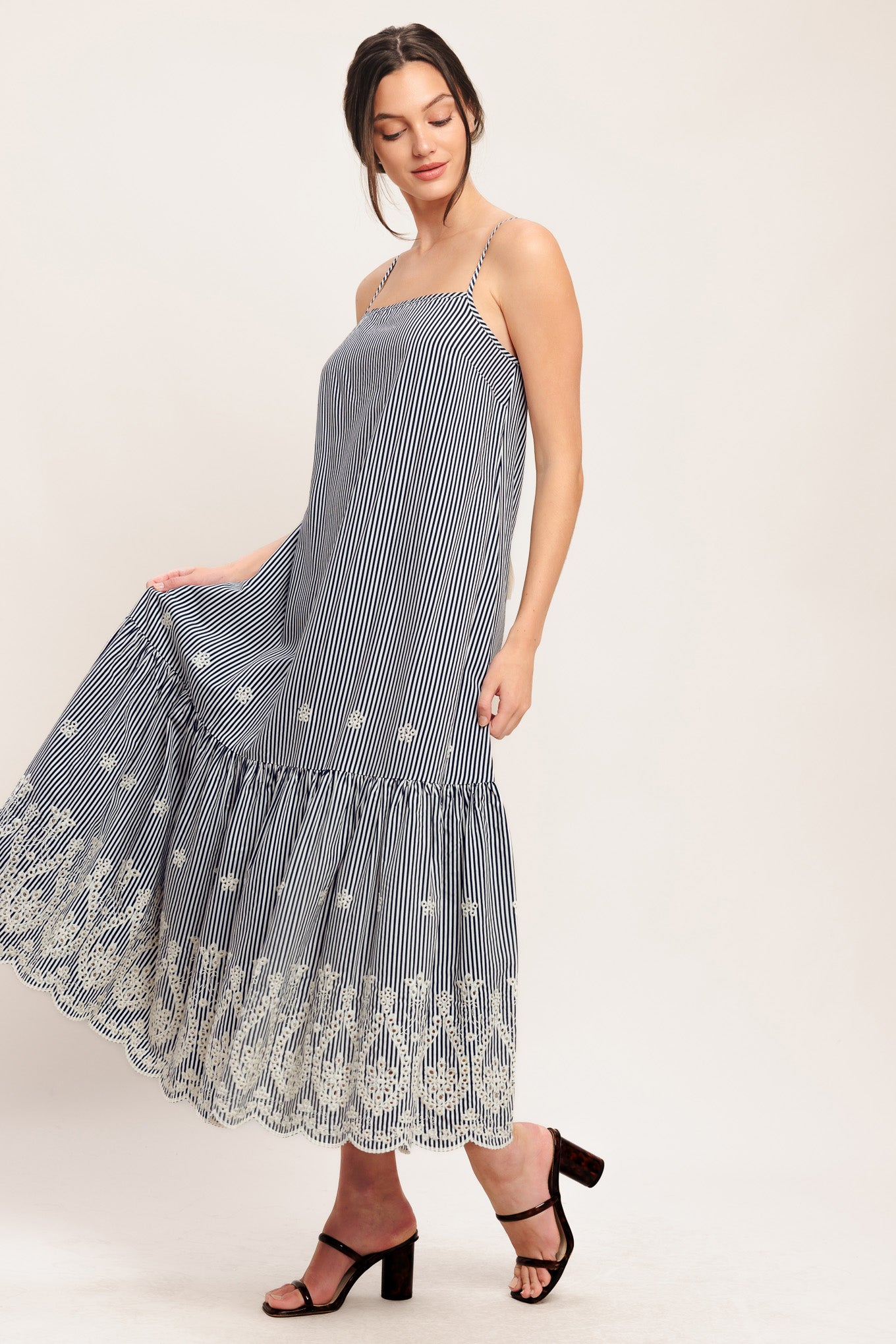 A striped woven midi dress featuring straight neckline, straps, embroidered hem, bare back with tie closure

Details:

Self: 100% Polyester

Size & Fit

-Model is 5`8" And Wearing Size Small
-Measurements Taken From Size Small
-Approx. Length: 51"