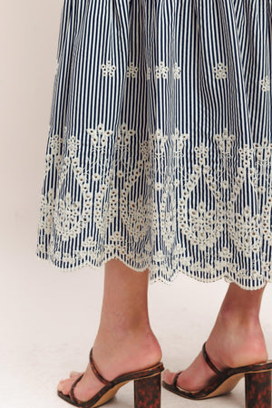 A striped woven midi dress featuring straight neckline, straps, embroidered hem, bare back with tie closure

Details:

Self: 100% Polyester

Size & Fit

-Model is 5`8" And Wearing Size Small
-Measurements Taken From Size Small
-Approx. Length: 51"