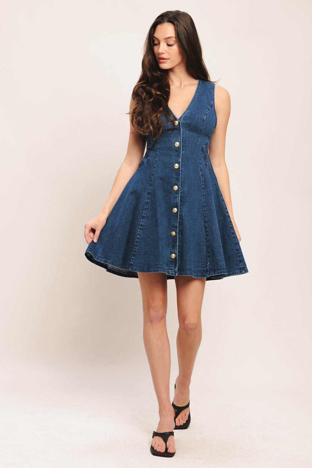 A washed denim mini dress featuring V neckline, sleeveless, non-functional front button down, circle skirt and back zipper closure

Details:

Self: 99% Cotton 1% Spandex

Size & Fit

-Model is 5`8" And Wearing Size Small
-Measurements Taken From Size Small
-Approx. Length: 34"