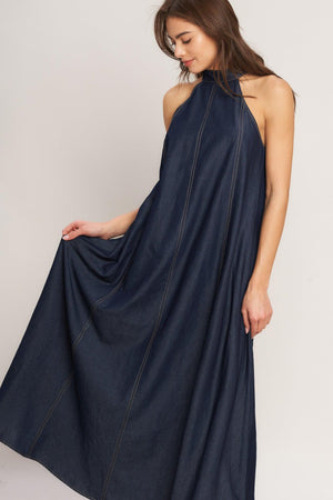 A solid woven midi halter dress with back neck button closure and side pockets