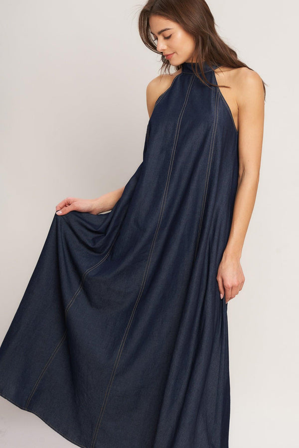 A solid woven midi halter dress with back neck button closure and side pockets