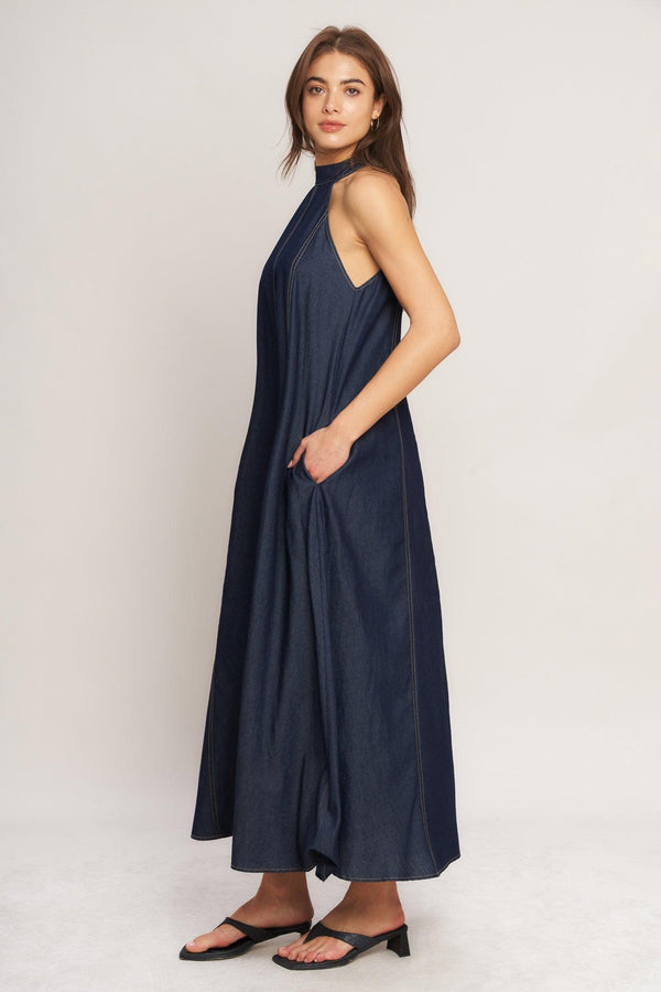 A solid woven midi halter dress with back neck button closure and side pockets