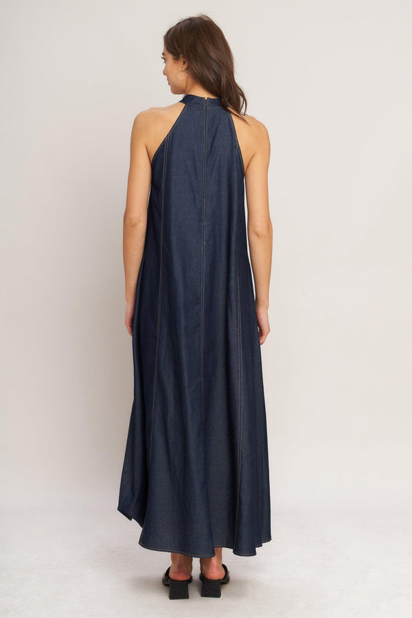 A solid woven midi halter dress with back neck button closure and side pockets