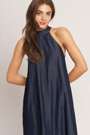 A solid woven midi halter dress with back neck button closure and side pockets
