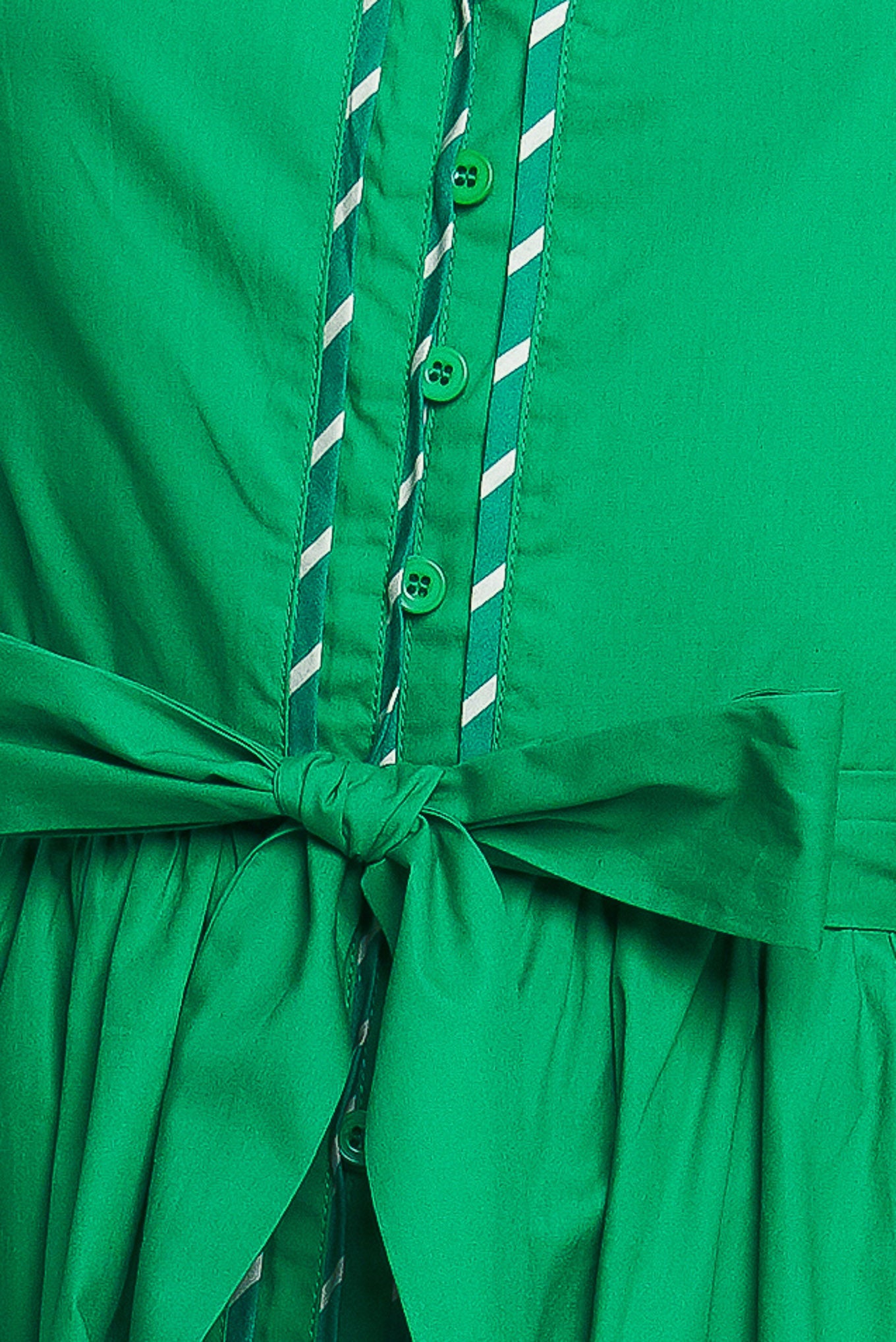 Woman wearing a green midi dress featuring V neckline, short flutter sleeve, button down, self sash tie, contrasting binding and full skirt | Flying Tomato