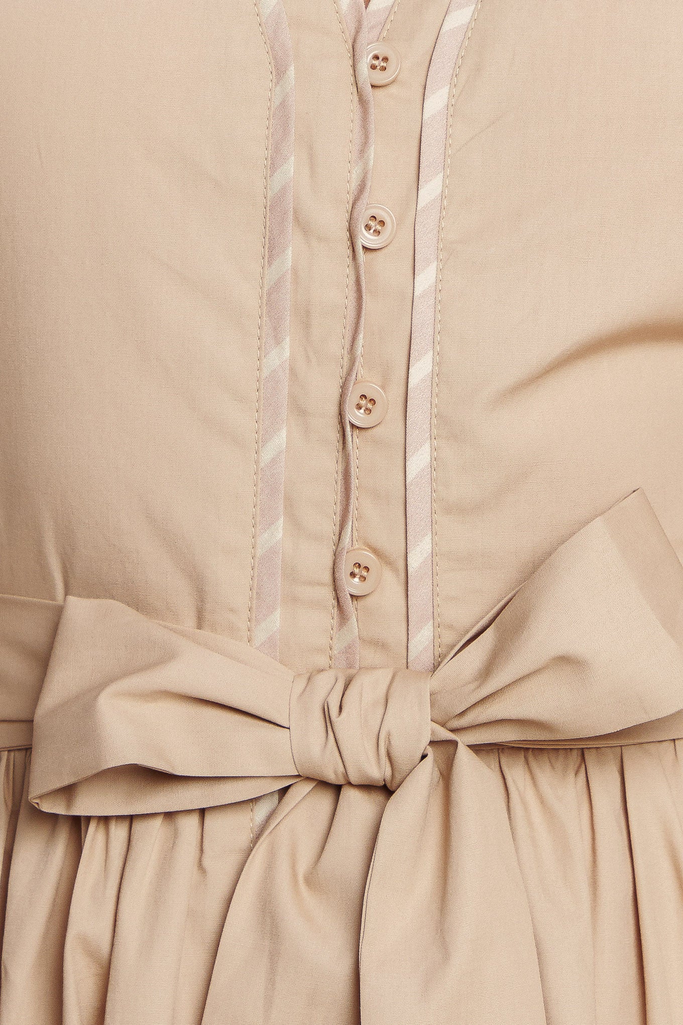 Woman wearing a beige midi dress featuring V neckline, short flutter sleeve, button down, self sash tie, contrasting binding and full skirt | Flying Tomato