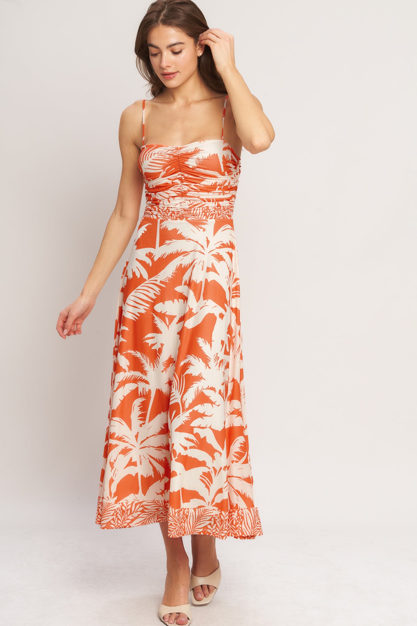 A printed power mesh midi dress featuring straight neckline, straps, shirred bodice, circle skirt and back zipper closure