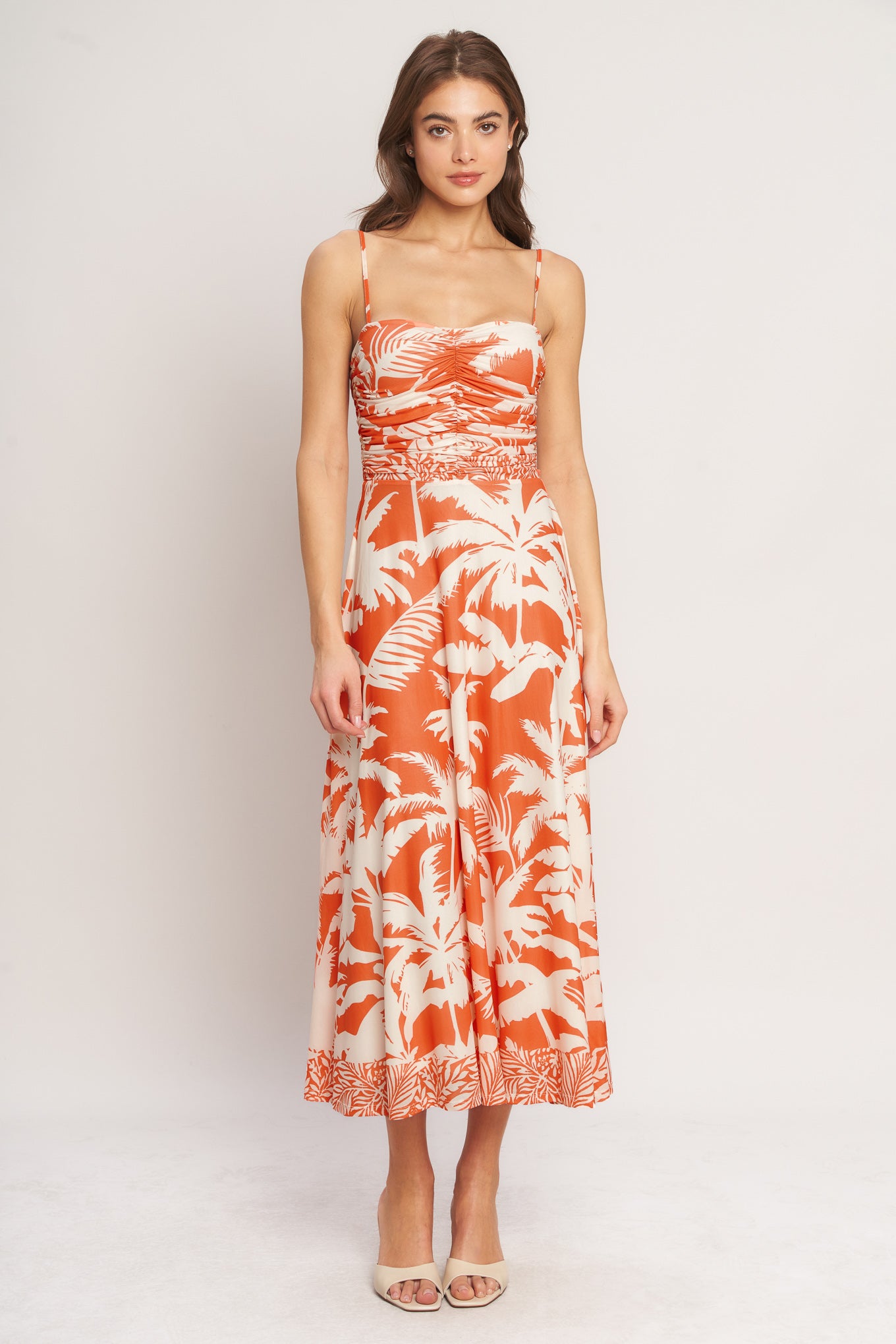 A printed power mesh midi dress featuring straight neckline, straps, shirred bodice, circle skirt and back zipper closure