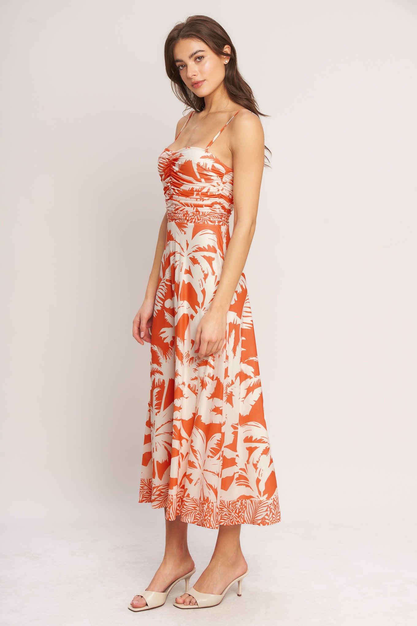 A printed power mesh midi dress featuring straight neckline, straps, shirred bodice, circle skirt and back zipper closure