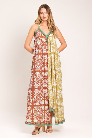 Woman wearing a rust and yellow long, floral patterned midi scarf dress | Flying Tomato