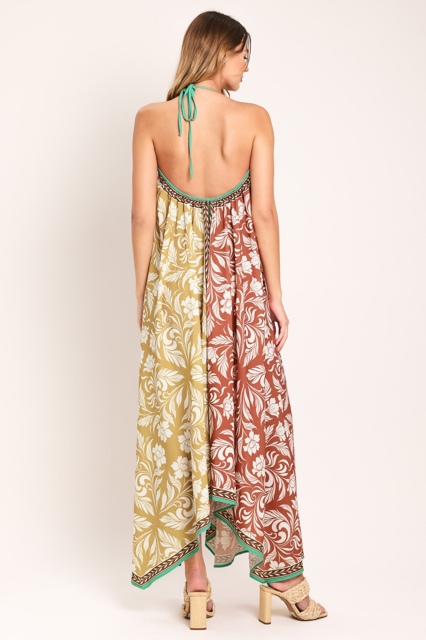 Woman wearing a rust and yellow long, floral patterned midi scarf dress | Flying Tomato