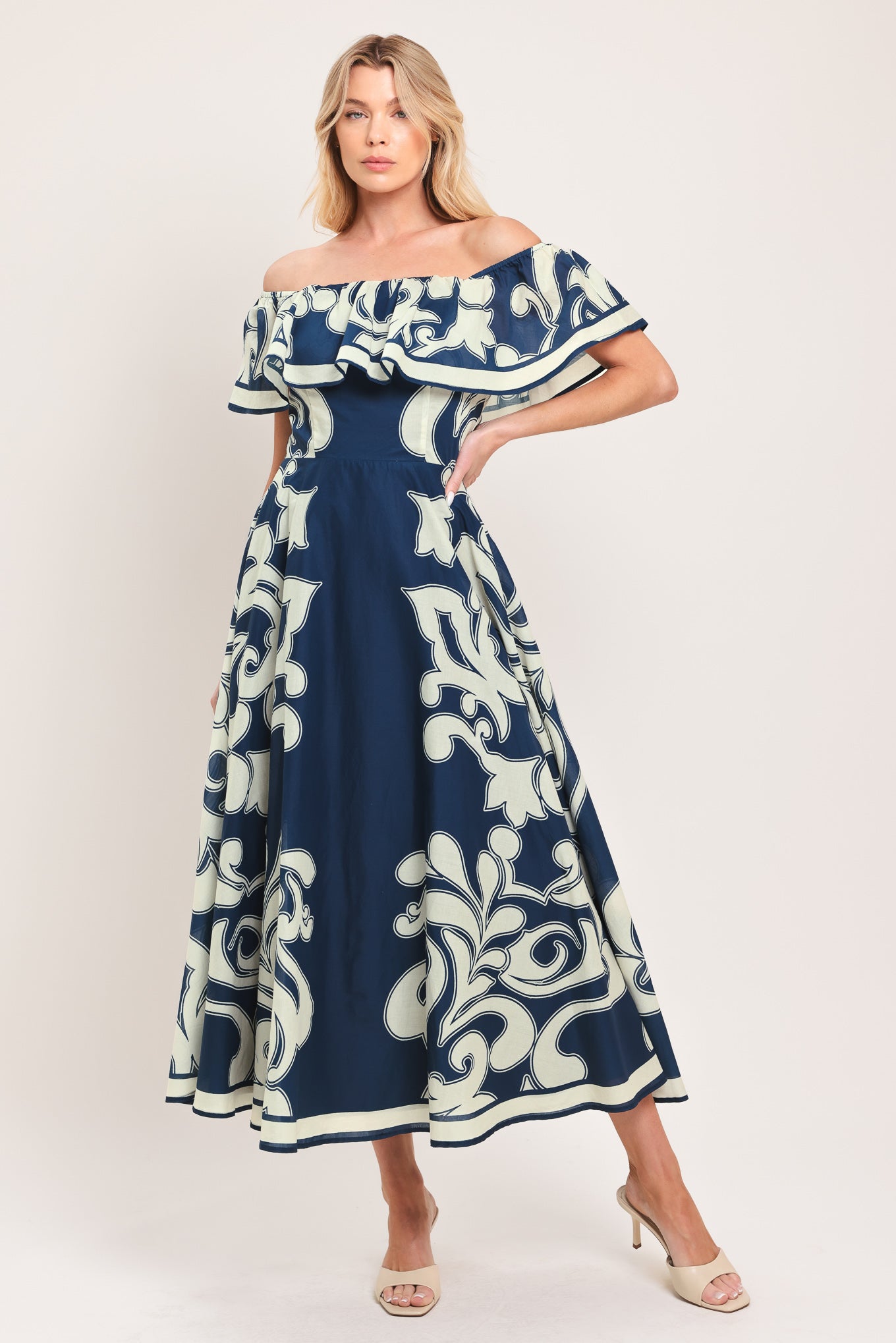 Woman wearing a blue and white patterned off the shoulder midi dress | Flying Tomato
