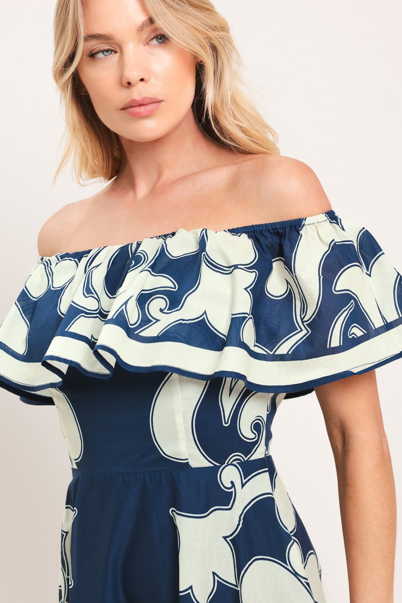 Woman wearing a blue and white patterned off the shoulder midi dress | Flying Tomato